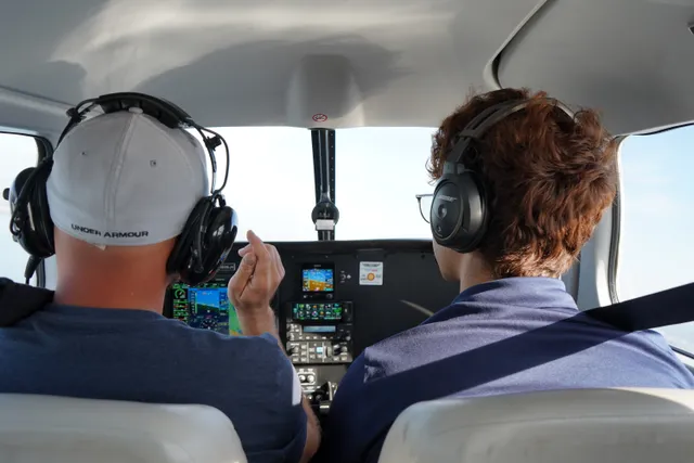 Instructor teaching student pilot preflight