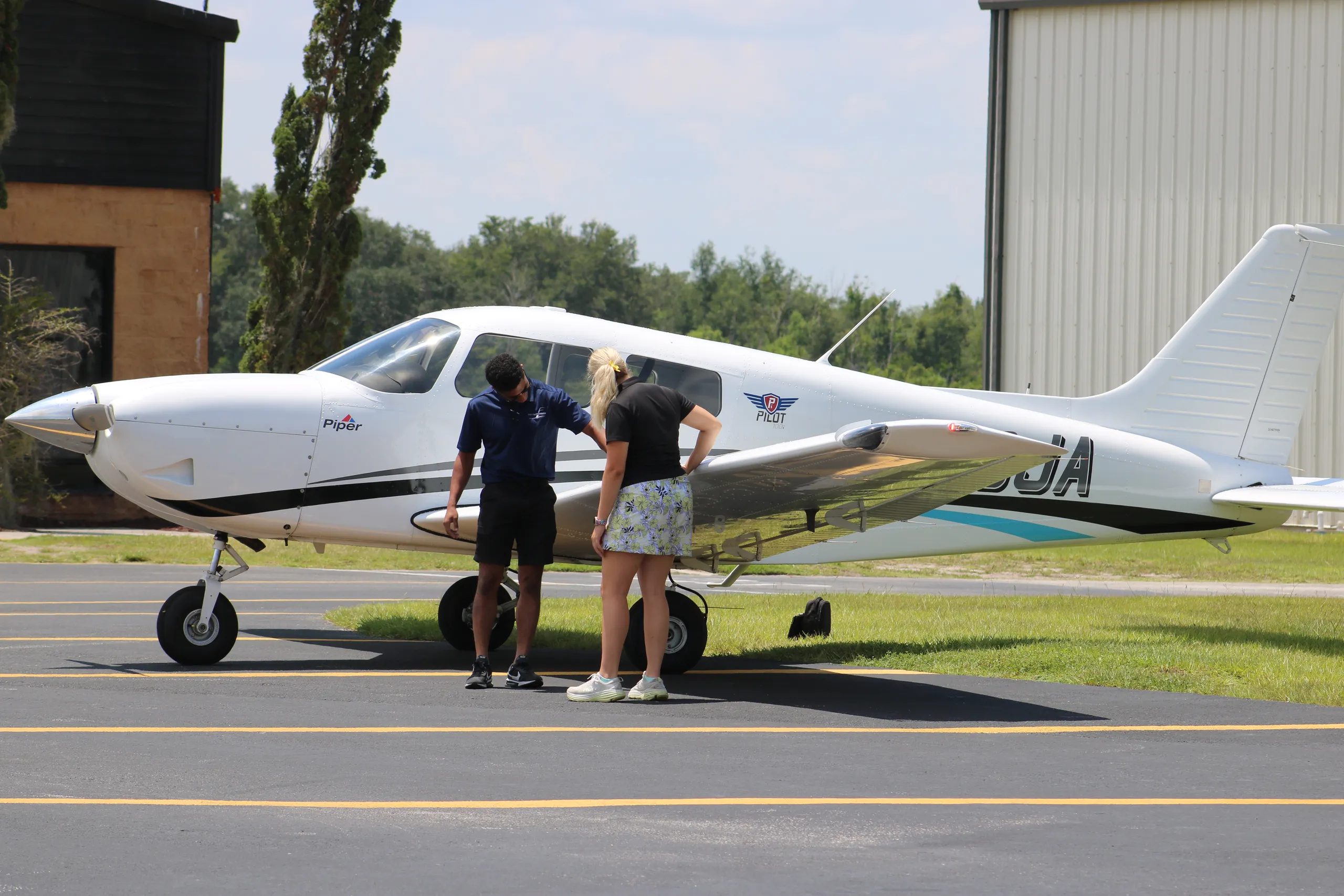 Instructor teaching student pilot preflight